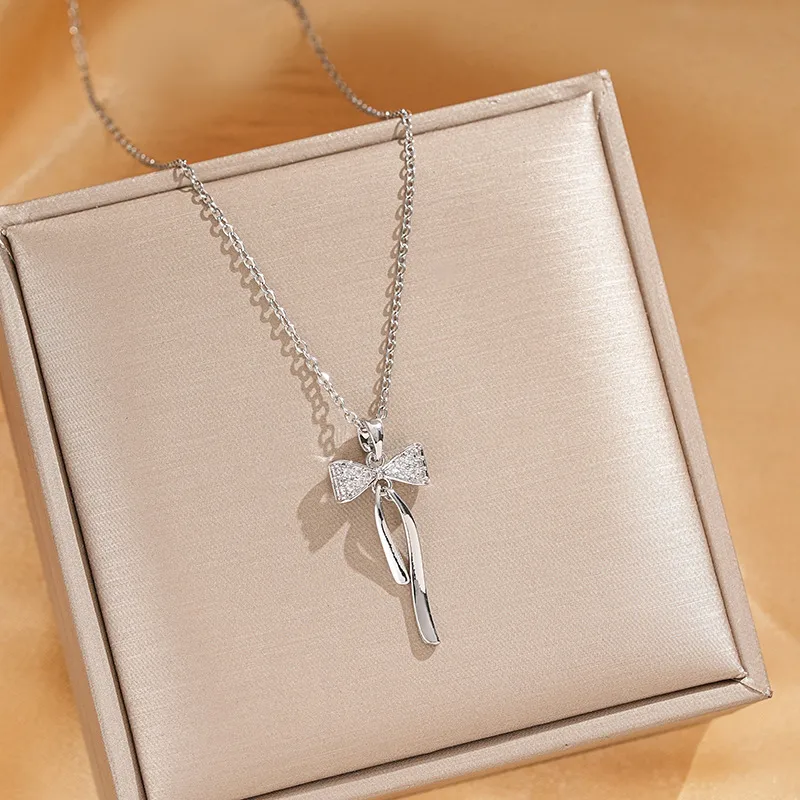 Vacation Classic Style Bow Knot Titanium Steel Copper Bowknot Inlaid Zircon Women's Pendant Necklace display picture 1