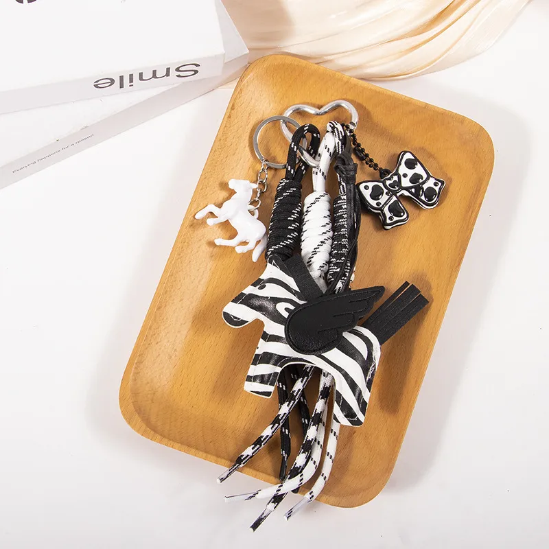 New MIU Cute Leather Pegasus Pendant Pony Bow Woven Rope Keychain Advanced Sense Bag Hanging display picture 3