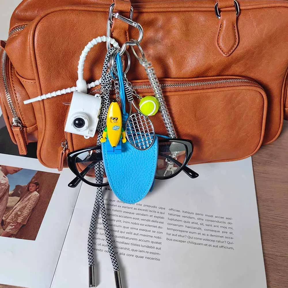 Blue Magnetic Eyeglass Clip Keychain Banana Man Tennis Camera Bag Storage Pendant American Style Mixed Material Keychain Accessory display picture 8