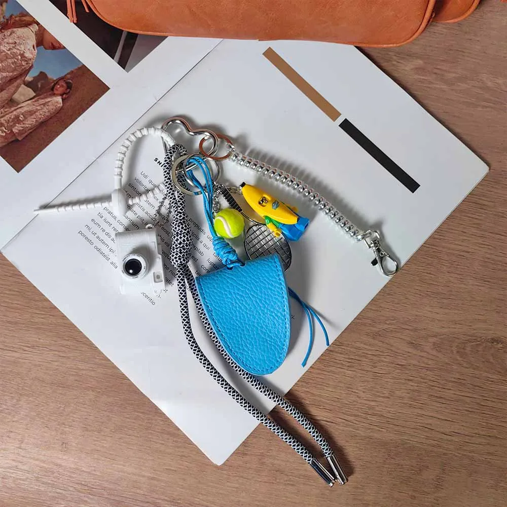 Blue Magnetic Eyeglass Clip Keychain Banana Man Tennis Camera Bag Storage Pendant American Style Mixed Material Keychain Accessory display picture 5