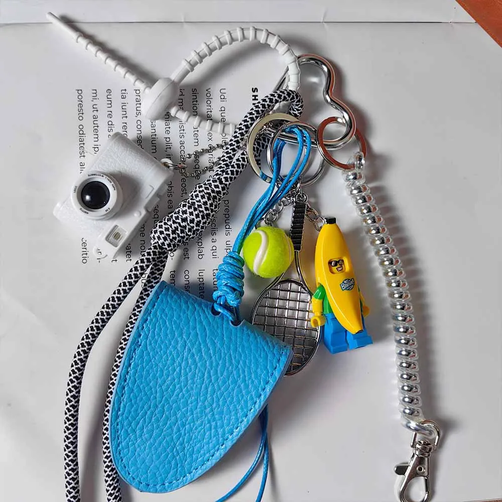 Blue Magnetic Eyeglass Clip Keychain Banana Man Tennis Camera Bag Storage Pendant American Style Mixed Material Keychain Accessory display picture 7